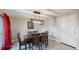 Cozy dining area with a modern light fixture, hardwood floors, and ample seating at 7248 S Broadway, Centennial, CO 80122