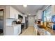 Modern kitchen with white cabinets, stainless steel appliances, and granite countertops at 7248 S Broadway, Centennial, CO 80122