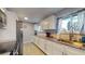 Updated kitchen featuring white cabinets, stainless steel appliances, and granite countertops at 7248 S Broadway, Centennial, CO 80122