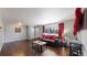 A spacious living room boasts hardwood floors, natural light, and an inviting seating arrangement with a view of the outdoors at 7248 S Broadway, Centennial, CO 80122