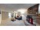 Charming living room with a stone fireplace, comfortable seating, and ample space for relaxation and entertaining at 7248 S Broadway, Centennial, CO 80122