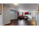 Cozy living room with hardwood floors, comfortable seating, and natural light from a front-facing window at 7248 S Broadway, Centennial, CO 80122