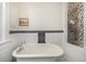 Bathroom with clawfoot tub, and black and white tile at 1944 W 33Rd Ave, Denver, CO 80211