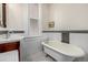 Bathroom with clawfoot tub, pedestal sink, and black and white tile at 1944 W 33Rd Ave, Denver, CO 80211