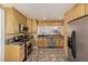 Spacious kitchen with stainless steel appliances and wood cabinets at 1944 W 33Rd Ave, Denver, CO 80211