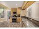 Well-equipped kitchen boasting granite counters & wood cabinets at 1944 W 33Rd Ave, Denver, CO 80211