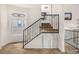 Interior staircase with metal railing and stained glass window at 1944 W 33Rd Ave, Denver, CO 80211