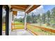 The home features a balcony with wood railings overlooking a wooded area at 11790 Huckleberry Drive Dr, Franktown, CO 80116