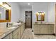 Spacious bathroom featuring a dual vanity with granite countertops, modern lighting and framed mirrors at 11790 Huckleberry Drive Dr, Franktown, CO 80116