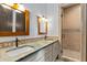 Elegant bathroom with double sinks, granite countertops, walk-in shower, and stylish fixtures at 11790 Huckleberry Drive Dr, Franktown, CO 80116