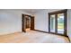 Bright, spacious bedroom featuring hardwood floors, neutral walls, and outdoor access to a balcony at 11790 Huckleberry Drive Dr, Franktown, CO 80116