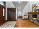 Grand foyer with a stone fireplace, wood floors, and a view into other rooms at 11790 Huckleberry Drive Dr, Franktown, CO 80116