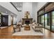 Inviting living room with high ceilings, stone fireplace, and seamless indoor-outdoor flow at 11790 Huckleberry Drive Dr, Franktown, CO 80116