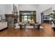 Bright living room featuring a stone fireplace, large windows, and comfortable seating at 11790 Huckleberry Drive Dr, Franktown, CO 80116