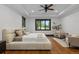 Large bedroom with ample windows, tray ceiling, hardwood floors, and comfortable seating area at 11790 Huckleberry Drive Dr, Franktown, CO 80116