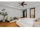 Bedroom with hardwood floors, two chairs, and an en-suite bathroom at 11790 Huckleberry Drive Dr, Franktown, CO 80116