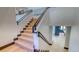 An interior staircase boasts wood stairs with dark trim and black metal handrails at 11790 Huckleberry Drive Dr, Franktown, CO 80116