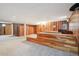 Spacious carpeted basement with wood paneled walls and unique wood platform at 10262 W Ida Ave # 243, Littleton, CO 80127