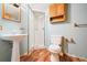 Functional bathroom featuring a pedestal sink, shower, toilet, and a practical wall cabinet at 10262 W Ida Ave # 243, Littleton, CO 80127