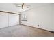 Cozy bedroom with a closet for storage, carpeted floors, and a ceiling fan at 10262 W Ida Ave # 243, Littleton, CO 80127