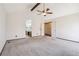 Bright bedroom offers vaulted ceilings, a ceiling fan, and easy access to the ensuite bathroom at 10262 W Ida Ave # 243, Littleton, CO 80127