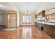 Open dining room with hardwood floors, and view into the kitchen area at 10262 W Ida Ave # 243, Littleton, CO 80127