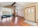 Bright living room with vaulted ceilings, hardwood floors, brick fireplace, and built-in seating area at 10262 W Ida Ave # 243, Littleton, CO 80127