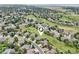Aerial view of a residential neighborhood with houses, green spaces, and winding roads at 9385 Prairie View Dr, Highlands Ranch, CO 80126