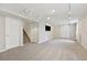 Versatile basement area with neutral carpet, track lighting, multiple windows, and access to the staircase at 9385 Prairie View Dr, Highlands Ranch, CO 80126