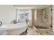 Bright bathroom featuring a soaking tub and glass-enclosed shower at 9385 Prairie View Dr, Highlands Ranch, CO 80126