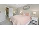 Comfortable bedroom with soft pink bedding, a ceiling fan, and soft lighting at 9385 Prairie View Dr, Highlands Ranch, CO 80126