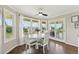 Sunlit dining area features lovely windows, a modern ceiling fan, and access to the deck at 9385 Prairie View Dr, Highlands Ranch, CO 80126