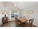 Traditional dining room with natural light and lovely chandelier at 9385 Prairie View Dr, Highlands Ranch, CO 80126