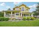 Attractive two-story home featuring an expansive covered porch and well-manicured lawn at 9385 Prairie View Dr, Highlands Ranch, CO 80126