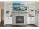 Close-up of the fireplace, featuring custom built-ins and a stone facade at 9385 Prairie View Dr, Highlands Ranch, CO 80126
