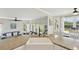 Open kitchen with a farmhouse sink, granite countertops, and wood floors seamlessly flowing into the adjacent living space at 9385 Prairie View Dr, Highlands Ranch, CO 80126