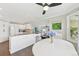 Bright kitchen flows into the dining area with white cabinets and stainless appliances at 9385 Prairie View Dr, Highlands Ranch, CO 80126