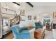 Open living area with hardwood floors, two-story ceilings, staircase, and natural light creating a welcoming space at 9385 Prairie View Dr, Highlands Ranch, CO 80126