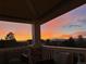 Relaxing outdoor porch area with comfortable seating and a scenic view of a colorful sunset at 9385 Prairie View Dr, Highlands Ranch, CO 80126