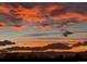 Beautiful and vibrant sunset with orange and red clouds over a mountain range at 9385 Prairie View Dr, Highlands Ranch, CO 80126