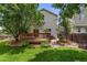 Large backyard with a well-maintained lawn, a deck, and a patio area at 11313 Haswell Dr, Parker, CO 80134