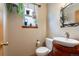 Cozy bathroom features a vessel sink on wood cabinet and a window decorated with plants at 11313 Haswell Dr, Parker, CO 80134