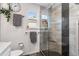 Bright bathroom with shower, hanging plant, and black accents at 11313 Haswell Dr, Parker, CO 80134