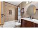 Bathroom featuring decorative vanity, tiled shower/tub, and unique wall clock at 11313 Haswell Dr, Parker, CO 80134