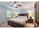 Bedroom with ceiling fan, dark wood furniture and decor at 11313 Haswell Dr, Parker, CO 80134