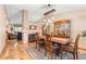 Open-concept dining room with hardwood floors, a fireplace, and views into the living room and staircase at 11313 Haswell Dr, Parker, CO 80134