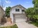 Charming two-story home with a well-manicured lawn, a two-car garage, and mature trees at 11313 Haswell Dr, Parker, CO 80134