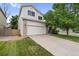 A charming home featuring a well-maintained front lawn, a two-car garage, and a classic exterior design at 11313 Haswell Dr, Parker, CO 80134