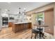 Modern kitchen featuring white cabinets, stainless steel appliances, a center island, and a breakfast nook at 11313 Haswell Dr, Parker, CO 80134