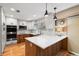 Spacious kitchen with white cabinets, modern appliances, hardwood floors, and a large center island at 11313 Haswell Dr, Parker, CO 80134
